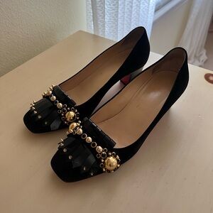 Christian Louboutin heels — black with gold details and studs